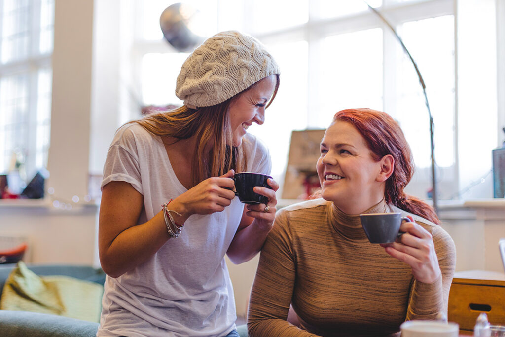 Two people indoors drinking coffee.