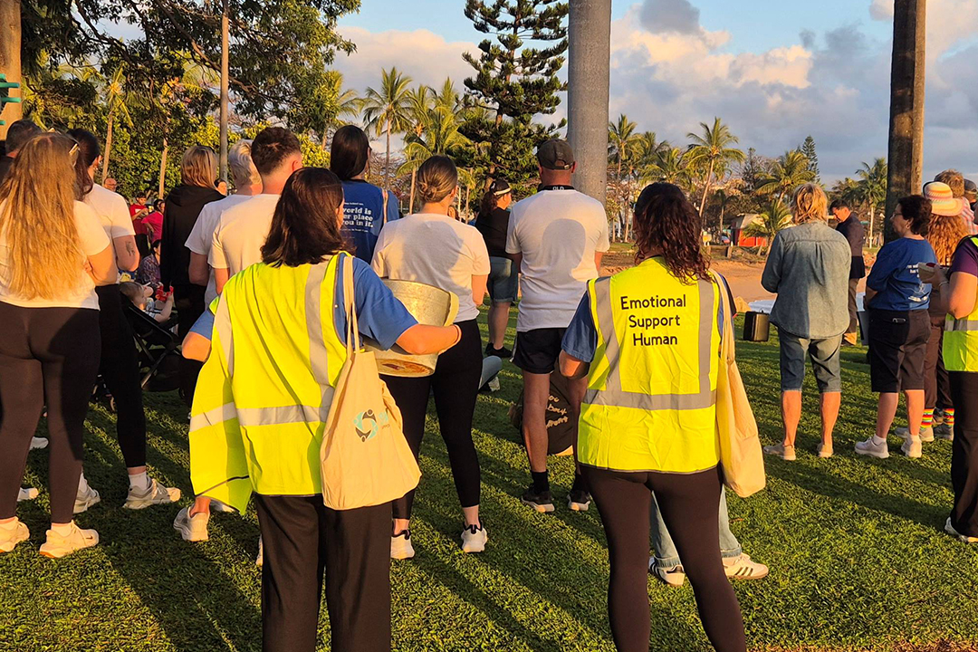 People wearing high visibility vests at an event